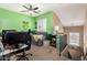 Cozy bedroom featuring green walls, decorative pillows, a ceiling fan, and a window for light at 4072 E Windsor Dr, Gilbert, AZ 85296