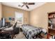 Cozy bedroom featuring neutral walls, a ceiling fan, and a window for natural light at 4072 E Windsor Dr, Gilbert, AZ 85296