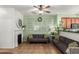 Cozy living room featuring decorative windows, a fireplace, and a comfortable sofa at 4072 E Windsor Dr, Gilbert, AZ 85296