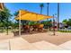 Community playground with a shaded area, surrounded by lush greenery at 4072 E Windsor Dr, Gilbert, AZ 85296