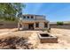Well-sized backyard features a covered patio and a built-in fire pit, ideal for outdoor living at 42098 W Balsa Dr, Maricopa, AZ 85138