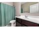 Bathroom featuring a vanity with a white sink, dark wood cabinet, and a shower with a teal curtain at 42098 W Balsa Dr, Maricopa, AZ 85138