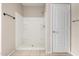 Bathroom featuring a clean white shower stall and tiled floor with a white door at 42098 W Balsa Dr, Maricopa, AZ 85138