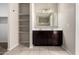 Bathroom featuring a double sink vanity with a dark wood finish and open shelving at 42098 W Balsa Dr, Maricopa, AZ 85138