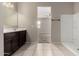 Bright bathroom with a large vanity and shower stall with tile flooring at 42098 W Balsa Dr, Maricopa, AZ 85138