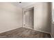 A spacious bedroom with neutral walls, plush carpet, and an entrance to another room at 42098 W Balsa Dr, Maricopa, AZ 85138