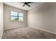 Bedroom with neutral walls, plush carpeting, ceiling fan, and window with outdoor view at 42098 W Balsa Dr, Maricopa, AZ 85138