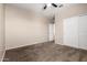 Bedroom with neutral walls, plush carpeting, ceiling fan, and closet with white sliding doors at 42098 W Balsa Dr, Maricopa, AZ 85138