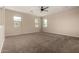 Spacious bedroom featuring neutral walls, plush carpeting, and three bright windows offering natural light at 42098 W Balsa Dr, Maricopa, AZ 85138