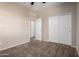 Bedroom with neutral walls, plush carpeting, white trim, and sliding door closet at 42098 W Balsa Dr, Maricopa, AZ 85138