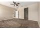 A large open bedroom with ample light from the two windows and plush carpet flooring at 42098 W Balsa Dr, Maricopa, AZ 85138