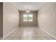 The empty dining room features neutral walls, tile floors and a modern chandelier at 42098 W Balsa Dr, Maricopa, AZ 85138