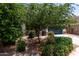 View of a well-maintained home surrounded by lush landscaping, a two-car garage, and desert landscaping at 42098 W Balsa Dr, Maricopa, AZ 85138