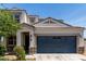 Beautiful home showcasing a two-car garage, stucco siding, and desert landscaping at 42098 W Balsa Dr, Maricopa, AZ 85138