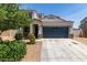 Charming single-Gathering home featuring stucco siding, a two-car garage, and neatly landscaped front yard at 42098 W Balsa Dr, Maricopa, AZ 85138