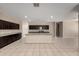 The spacious kitchen features dark cabinets, granite countertops and an open floorplan at 42098 W Balsa Dr, Maricopa, AZ 85138