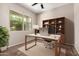 Well-lit office with large window, built-in shelves and ceiling fan for comfort at 42098 W Balsa Dr, Maricopa, AZ 85138