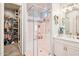 Modern bathroom featuring a glass-enclosed shower, updated fixtures, and a view into the closet at 4215 E Ronald St, Gilbert, AZ 85295
