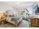 Cozy bedroom with an ornate headboard, plush bedding, and a serene window view at 4215 E Ronald St, Gilbert, AZ 85295