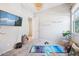 Minimalist bedroom with natural light, hardwood floors, and a flat-screen television at 4215 E Ronald St, Gilbert, AZ 85295