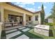 Back patio with seating area, tiled flooring, and gas fire pit for outdoor living at 4215 E Ronald St, Gilbert, AZ 85295