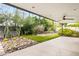 An outdoor covered patio with an area of artificial turf and desert landscaping with barrel cactus at 4312 E Roma Ave, Phoenix, AZ 85018