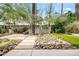 Tranquil backyard features desert landscaping, mature trees, and stone pathway at 4312 E Roma Ave, Phoenix, AZ 85018