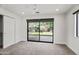 Bedroom with a ceiling fan and sliding glass doors leading to the backyard at 4312 E Roma Ave, Phoenix, AZ 85018