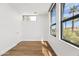 Bright bedroom with hardwood floors and a view of swaying palm trees at 4312 E Roma Ave, Phoenix, AZ 85018