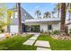 Modern home's exterior features professionally landscaped yard, walkway, with architectural trees and desert foliage at 4312 E Roma Ave, Phoenix, AZ 85018