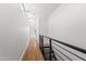 Bright hallway featuring hardwood floors and modern black railing at 4312 E Roma Ave, Phoenix, AZ 85018