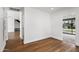 Upstairs hallway with hardwood floors leads to a bedroom with outdoor views at 4312 E Roma Ave, Phoenix, AZ 85018