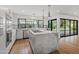 Contemporary kitchen boasts stainless appliances, gray stone island, and hardwood floors open to patio at 4312 E Roma Ave, Phoenix, AZ 85018