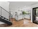 Modern kitchen features white cabinetry, stone island, stainless steel appliances, and access to outdoor living area at 4312 E Roma Ave, Phoenix, AZ 85018