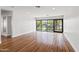 Spacious living room with gleaming hardwood floors and sliding glass doors to backyard at 4312 E Roma Ave, Phoenix, AZ 85018