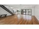 Open-concept living room shows staircase, hardwood floors, and large glass doors bringing the outside in at 4312 E Roma Ave, Phoenix, AZ 85018