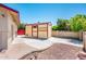 Backyard features a shed with shelving and a concrete pad, complemented by a well-maintained brick wall at 4414 S Ventura Dr, Tempe, AZ 85282