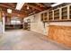 Large basement with exposed beams, a workbench, and shelving, offering ample storage and workspace at 4414 S Ventura Dr, Tempe, AZ 85282