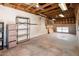 Spacious basement area with exposed beams, unfinished walls, and a window offering natural light at 4414 S Ventura Dr, Tempe, AZ 85282