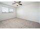 This bedroom features neutral carpeting, a ceiling fan, and a window for natural light at 4414 S Ventura Dr, Tempe, AZ 85282