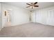 Spacious bedroom with carpeted floor, ceiling fan, and closet space at 4414 S Ventura Dr, Tempe, AZ 85282