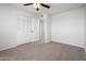 This bedroom features neutral carpeting and a closet for storage at 4414 S Ventura Dr, Tempe, AZ 85282