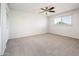 Bright bedroom with neutral walls, ceiling fan, carpet flooring, and a closet at 4414 S Ventura Dr, Tempe, AZ 85282