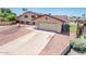 View of the home's side, a long driveway, garage, and view of pool in backyard at 4414 S Ventura Dr, Tempe, AZ 85282