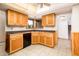 Efficient kitchen design featuring wooden cabinets, tiled flooring, and a corner sink at 4414 S Ventura Dr, Tempe, AZ 85282