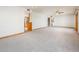 Open-concept living room featuring carpet floors, neutral walls, ceiling fan, and staircase access at 4414 S Ventura Dr, Tempe, AZ 85282
