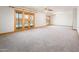 Spacious living room with neutral carpet, two sets of French doors, and a ceiling fan at 4414 S Ventura Dr, Tempe, AZ 85282