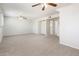 This living room features neutral carpeting, ceiling fans, and an open floorplan at 4414 S Ventura Dr, Tempe, AZ 85282