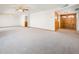 Expansive living room featuring neutral walls and carpet, plus elegant French door access at 4414 S Ventura Dr, Tempe, AZ 85282