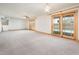 Spacious living room with carpet, ceiling fan and a view of the sparkling swimming pool through sliding doors at 4414 S Ventura Dr, Tempe, AZ 85282